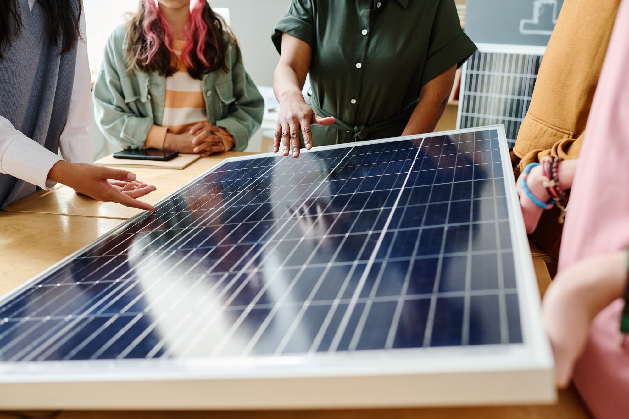 Teacher showing the work of solar panel to students